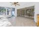 The Florida room includes ceramic tile floor, ceiling fan, and sliding glass door to the backyard at 5010 109Th N Way, St Petersburg, FL 33708