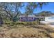Charming light purple single-story home with mature tree and black chain link fence at 5010 109Th N Way, St Petersburg, FL 33708