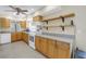 The kitchen features wood cabinets, white appliances, and terrazzo flooring at 5010 109Th N Way, St Petersburg, FL 33708