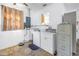 Laundry room with utility sink, washer, dryer, and storage cabinets at 5010 109Th N Way, St Petersburg, FL 33708