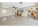 Open concept living room with TV, views to the kitchen, and tile floors, perfect for entertaining at 5010 109Th N Way, St Petersburg, FL 33708