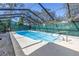 Sparkling swimming pool in screened enclosure with surrounding patio, offering a private outdoor oasis at 5010 109Th N Way, St Petersburg, FL 33708