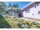 View of the sunroom addition on the back of the light purple single story home at 5010 109Th N Way, St Petersburg, FL 33708