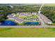Aerial view of a community with ponds, landscaping, a community pool, and lots of green space at 5332 Riverwalk Preserve Dr, New Port Richey, FL 34653