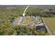 Aerial view of a new construction community with ponds, pool and dense landscaping at 5332 Riverwalk Preserve Dr, New Port Richey, FL 34653