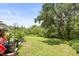 Enjoy the outdoors with this spacious backyard surrounded by mature trees and lush greenery at 5332 Riverwalk Preserve Dr, New Port Richey, FL 34653