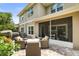 An outdoor patio features wicker furniture and views of the private, screened-in porch and backyard at 5332 Riverwalk Preserve Dr, New Port Richey, FL 34653