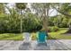 Relax on this gravel path in comfortable chairs with a view of a canal surrounded by nature at 5332 Riverwalk Preserve Dr, New Port Richey, FL 34653