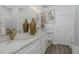 Elegant bathroom featuring double sinks, a marble countertop, and modern fixtures at 5332 Riverwalk Preserve Dr, New Port Richey, FL 34653