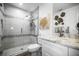 Bright bathroom featuring a glass-enclosed shower, marble countertop, and elegant fixtures at 5332 Riverwalk Preserve Dr, New Port Richey, FL 34653
