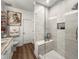 Modern bathroom with glass shower, marble countertop vanity, neutral paint, and luxury tiled shower accents at 5332 Riverwalk Preserve Dr, New Port Richey, FL 34653