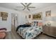 Comfortable bedroom with light decor, ceiling fan, and wood flooring at 5332 Riverwalk Preserve Dr, New Port Richey, FL 34653