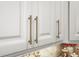 Close-up shot of kitchen cabinets with elegant gold hardware and soft, ambient lighting at 5332 Riverwalk Preserve Dr, New Port Richey, FL 34653