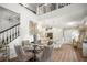 Open-concept living space with dining area, kitchen, and staircase with modern finishes at 5332 Riverwalk Preserve Dr, New Port Richey, FL 34653