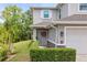 Charming two-story home featuring a gray front door with a festive wreath and well-manicured landscaping at 5332 Riverwalk Preserve Dr, New Port Richey, FL 34653