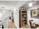 Hallway with wood floors, a bookcase, and decorative items at 5332 Riverwalk Preserve Dr, New Port Richey, FL 34653