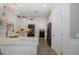 Well-lit kitchen with stone countertops, black stainless appliances, and seamless flow to dining and living areas at 5332 Riverwalk Preserve Dr, New Port Richey, FL 34653