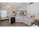 Stylish kitchen featuring marble countertops, black stainless appliances, and plenty of natural light at 5332 Riverwalk Preserve Dr, New Port Richey, FL 34653