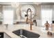 Close-up of the kitchen sink area showcasing marble countertop and a stylish faucet at 5332 Riverwalk Preserve Dr, New Port Richey, FL 34653