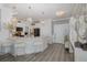 Bright kitchen features elegant chandeliers, a stylish island with seating, and modern appliances at 5332 Riverwalk Preserve Dr, New Port Richey, FL 34653