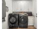 Laundry room with modern appliances, cabinets, and counter space at 5332 Riverwalk Preserve Dr, New Port Richey, FL 34653