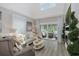 Bright living room with high ceilings, sliding glass doors to the patio, and a decorative fireplace at 5332 Riverwalk Preserve Dr, New Port Richey, FL 34653