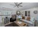 Comfortable living room featuring wood floors, coffered ceiling, and stylish decor at 5332 Riverwalk Preserve Dr, New Port Richey, FL 34653