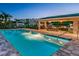 Community pool with lounge seating, a covered outdoor kitchen, and nearby residential buildings at 5332 Riverwalk Preserve Dr, New Port Richey, FL 34653