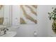 Stylish powder room with a modern sink, decorative mirror, and elegant artwork at 5332 Riverwalk Preserve Dr, New Port Richey, FL 34653