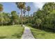 A scenic walking path leads through lush greenery, offering a peaceful retreat at 5332 Riverwalk Preserve Dr, New Port Richey, FL 34653