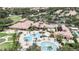 Expansive aerial view of the community clubhouse, swimming pools, and recreation areas, surrounded by lush landscaping at 5646 Sunset Falls Dr, Apollo Beach, FL 33572
