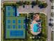 Aerial view of a tennis court, pool, clubhouse, parking, and landscaping at 5646 Sunset Falls Dr, Apollo Beach, FL 33572
