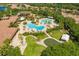 Gorgeous aerial view of the community clubhouse, pools, and amenities, set amidst lush landscaping and scenic surroundings at 5646 Sunset Falls Dr, Apollo Beach, FL 33572