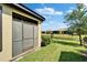 Serene backyard view with lush green grass and a tranquil pond behind the property at 5646 Sunset Falls Dr, Apollo Beach, FL 33572