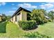 Lush backyard featuring well-manicured landscaping and a charming outdoor space at 5646 Sunset Falls Dr, Apollo Beach, FL 33572