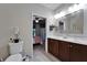 View of the bathroom leading to a bedroom, featuring double sinks, and decorative mirror and lighting at 5646 Sunset Falls Dr, Apollo Beach, FL 33572