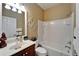 Well-lit bathroom featuring a vanity, toilet, tub and shower combo at 5646 Sunset Falls Dr, Apollo Beach, FL 33572