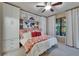 Charming bedroom with a built-in closet, overhead fan, and decoratively patterned bedspread at 5646 Sunset Falls Dr, Apollo Beach, FL 33572
