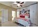 Cozy bedroom with bright, built-in storage, unique map art, and red accent pillows on the bed at 5646 Sunset Falls Dr, Apollo Beach, FL 33572