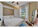 Cozy bedroom featuring a Murphy bed, ceiling fan, and a view of the outdoors at 5646 Sunset Falls Dr, Apollo Beach, FL 33572
