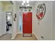 Inviting foyer with a red front door, decorative mirror, and a 'Welcome' mat at 5646 Sunset Falls Dr, Apollo Beach, FL 33572
