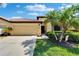 Charming one-story home with mature landscaping, a manicured lawn, and a two-car garage at 5646 Sunset Falls Dr, Apollo Beach, FL 33572