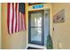 Welcoming front entry featuring a storm door and American flag, creating a patriotic statement at 5646 Sunset Falls Dr, Apollo Beach, FL 33572