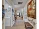 Hallway with access to the laundry room and a view of the living spaces at 5646 Sunset Falls Dr, Apollo Beach, FL 33572