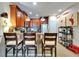 Cozy kitchen features wooden cabinetry, a breakfast bar with seating, and stainless steel appliances at 5646 Sunset Falls Dr, Apollo Beach, FL 33572