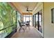Screened-in lanai with comfortable seating and lush tropical views at 5646 Sunset Falls Dr, Apollo Beach, FL 33572
