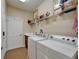 Convenient laundry room with a washer, dryer, sink and extra storage space at 5646 Sunset Falls Dr, Apollo Beach, FL 33572
