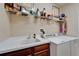 Functional laundry area with ample counter space, a sink, and modern appliances at 5646 Sunset Falls Dr, Apollo Beach, FL 33572