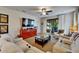 Bright living room featuring plush sofas, a ceiling fan, and sliding glass doors to the lanai at 5646 Sunset Falls Dr, Apollo Beach, FL 33572