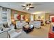 Comfortable living room showcasing a neutral color palette, reclining sofas, and access to dining area at 5646 Sunset Falls Dr, Apollo Beach, FL 33572